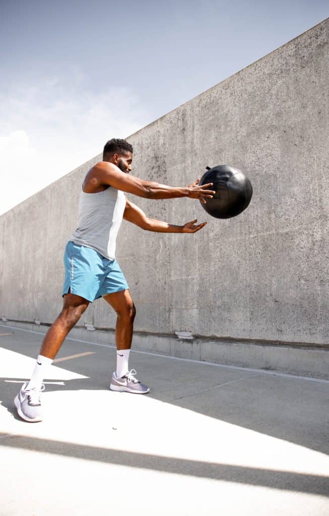 guy doing a wall ball exercise