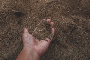 Close-Up Photo of Person Holding dirt full of humic acid