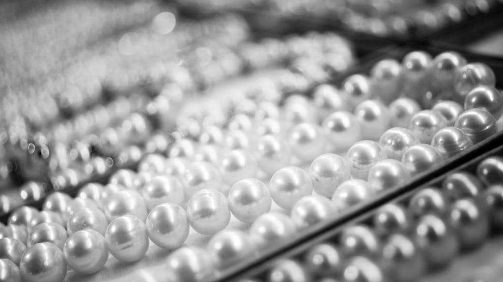 A close-up view of elegant pearl necklaces showcasing their shine and texture.