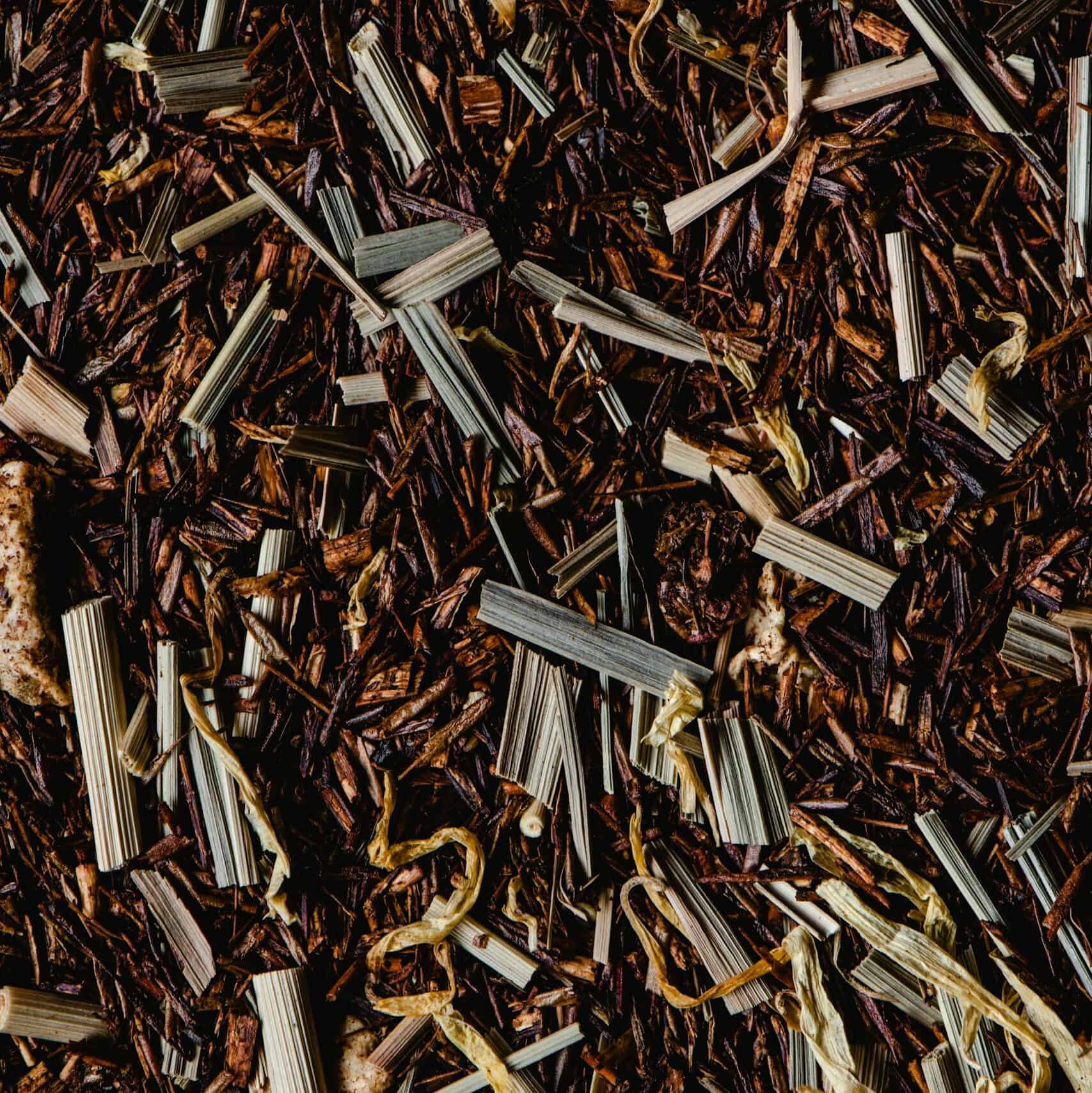 Close-up of dried rooibos and lemongrass blend highlighting texture and color.