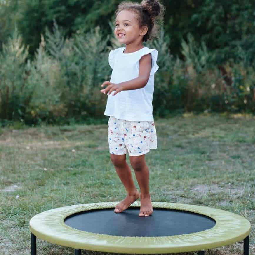 a young girl playing trampoline, rebounding to move lymph